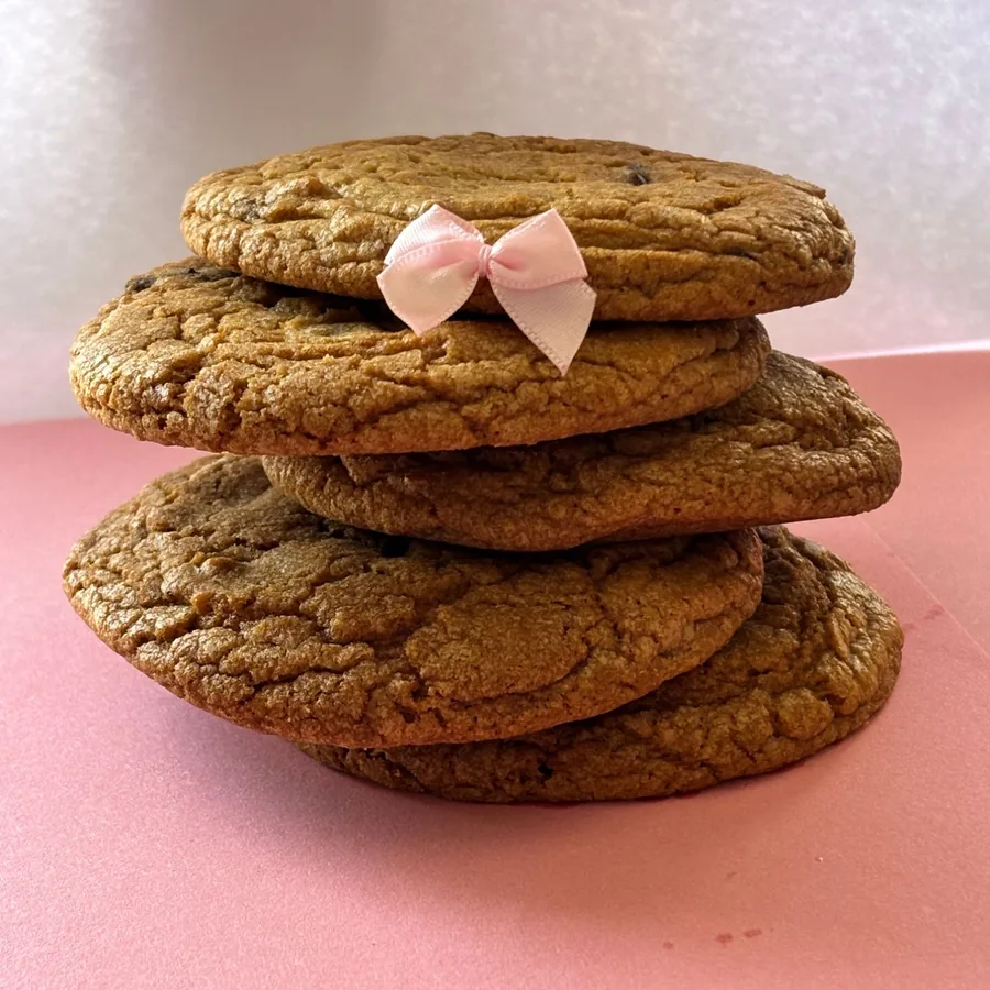 A stack of Grace's chocolate chip cookies, finished with a pink bow